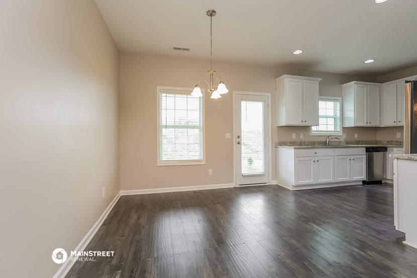 the kitchen and living room of a new home