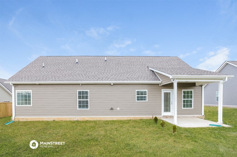 the view of a gray house from the back of it
