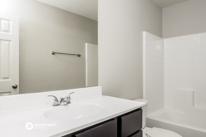 a bathroom with a sink and a shower and a toilet