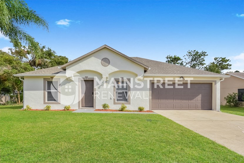 a house with a lawn and a garage