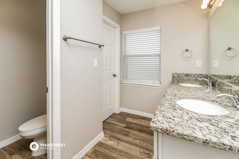 a bathroom with a sink and a toilet and a shower