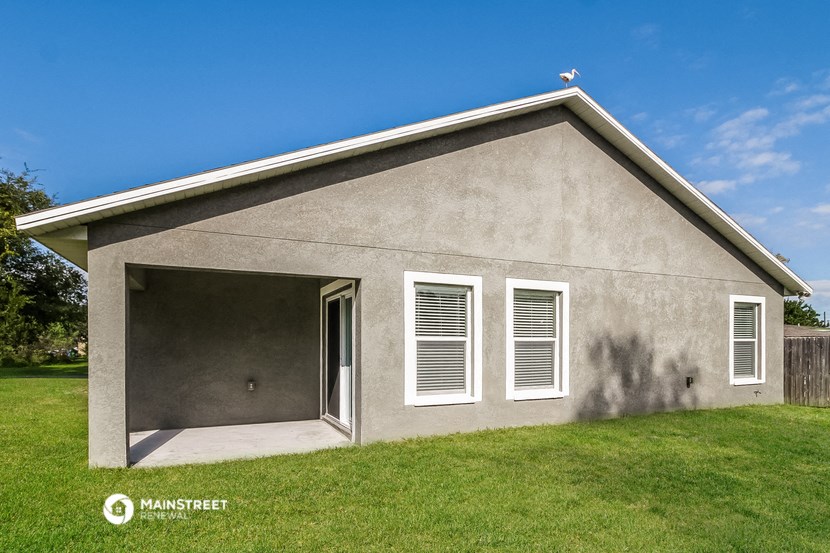 a garage with a garage door open in front of a house