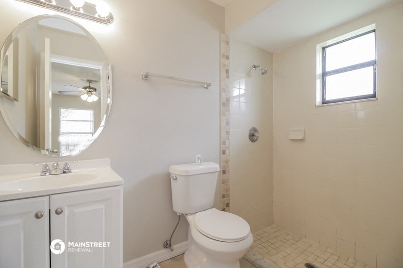 a white bathroom with a toilet and a sink