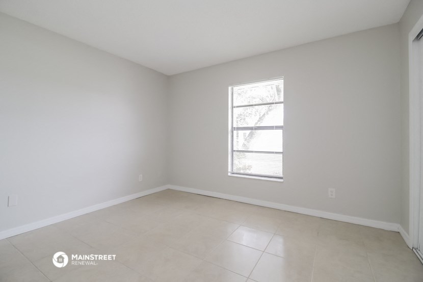 the living room of an empty house with a window