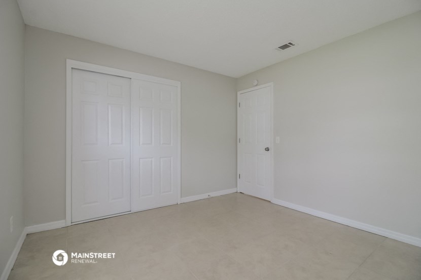 the living room of a home with two white doors