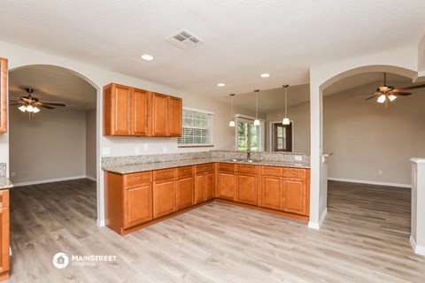 a kitchen with wooden cabinets and a counter top
