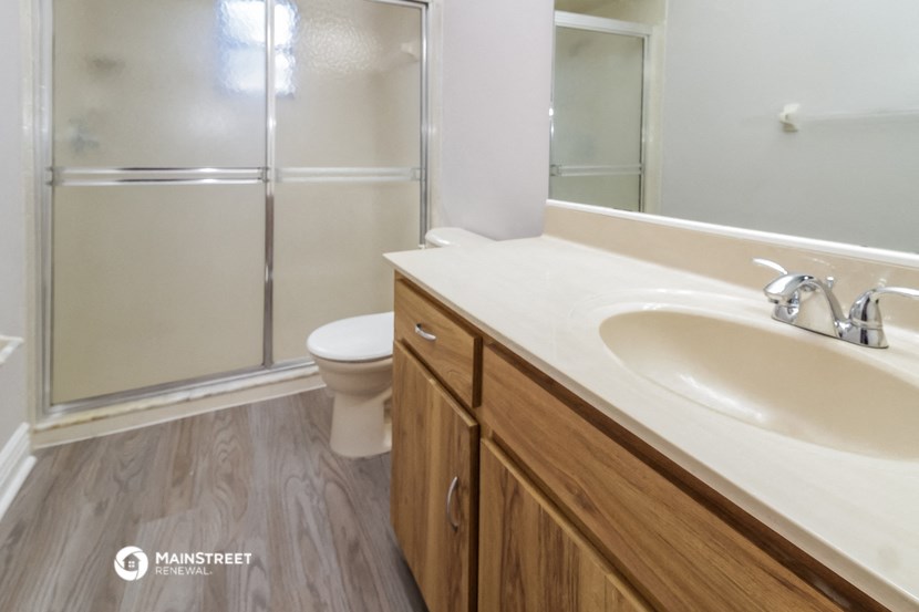a bathroom with a sink and a shower and a toilet