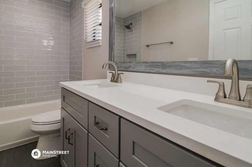 a bathroom with a sink and a toilet and a mirror