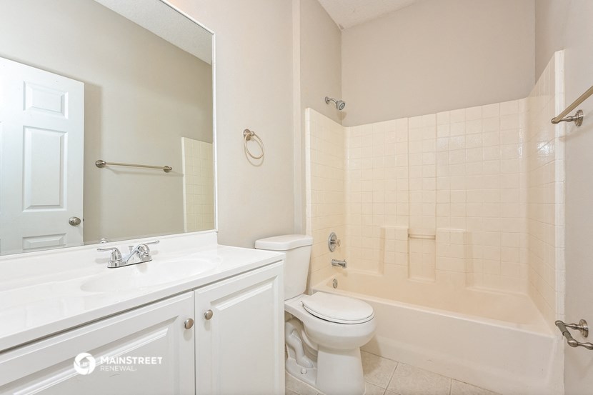 a white bathroom with a toilet and a sink