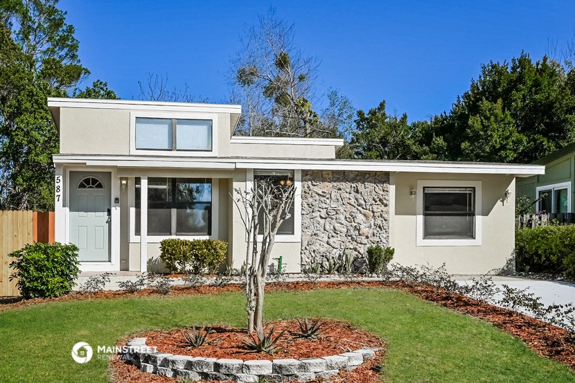 a white house with a lawn and a garden