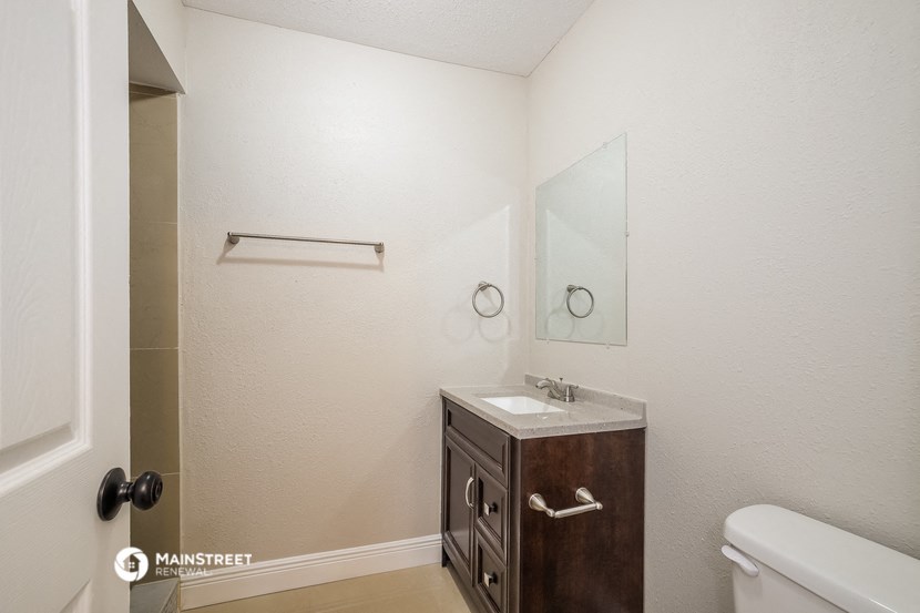 a bathroom with a sink and a mirror and a toilet