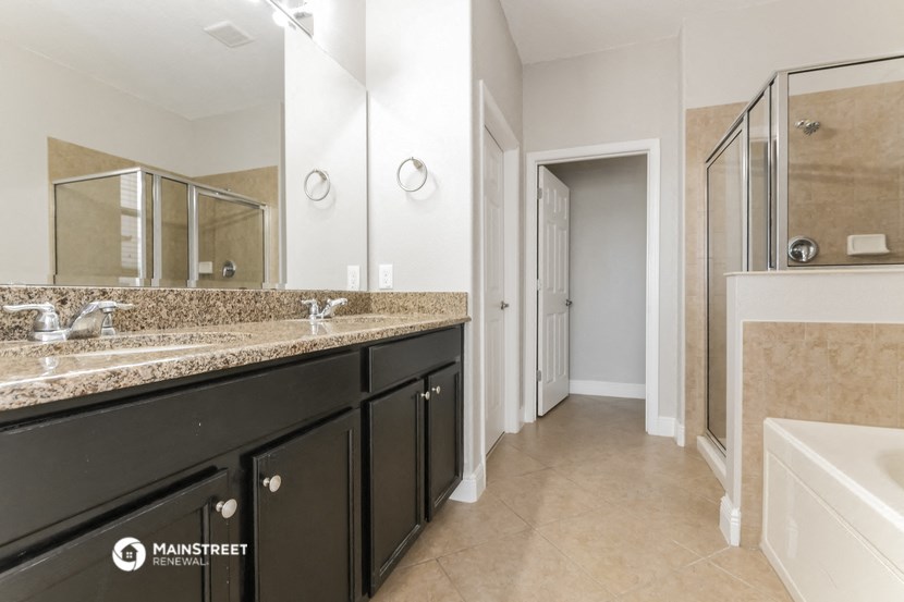 a bathroom with two sinks and a large mirror