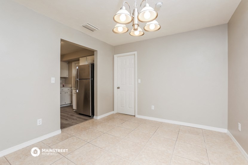 the spacious living room and kitchen with stainless steel appliances