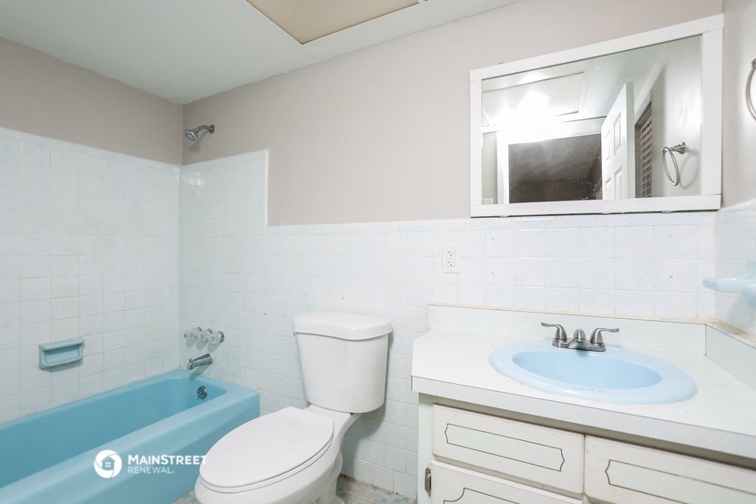 a bathroom with a sink toilet and a bath tub
