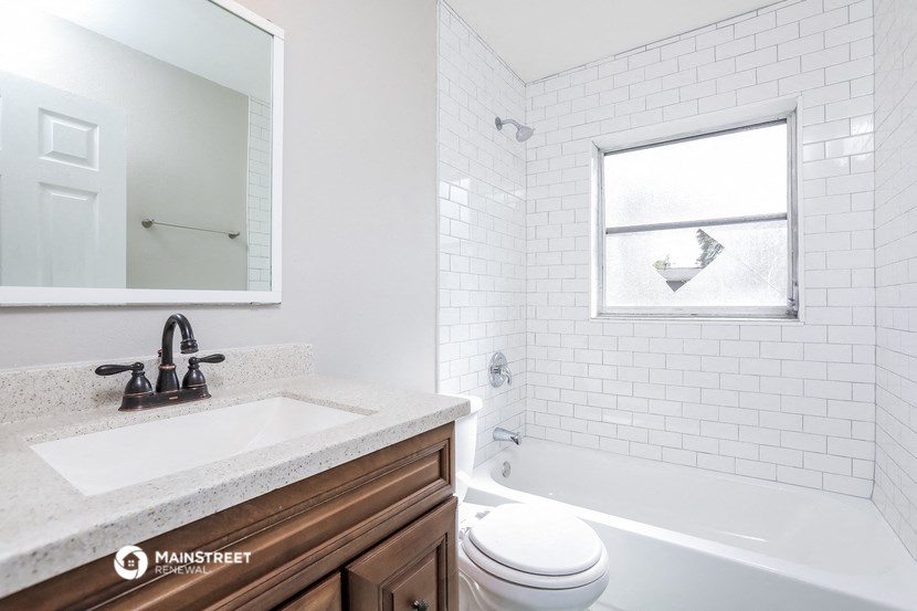 a bathroom with a sink and a toilet and a bath tub