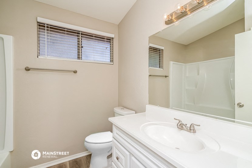 a bathroom with a sink and a toilet and a shower