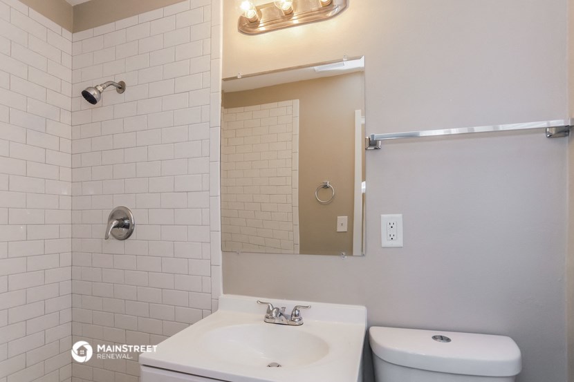 a bathroom with a sink and a mirror and a toilet