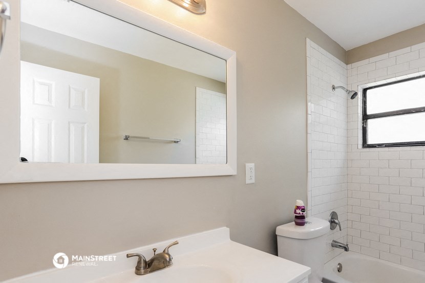 a bathroom with a sink and a mirror and a toilet