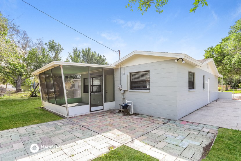 a white house with a patio and a glass door