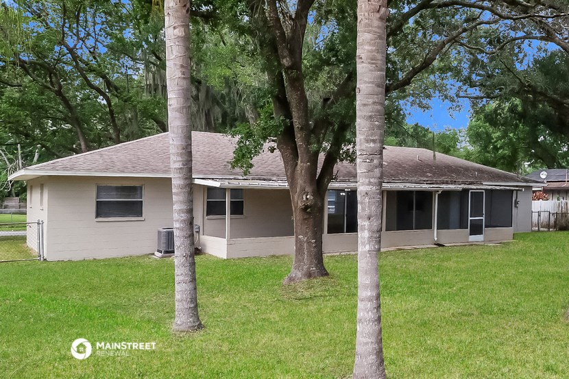 a white house with trees in front of it