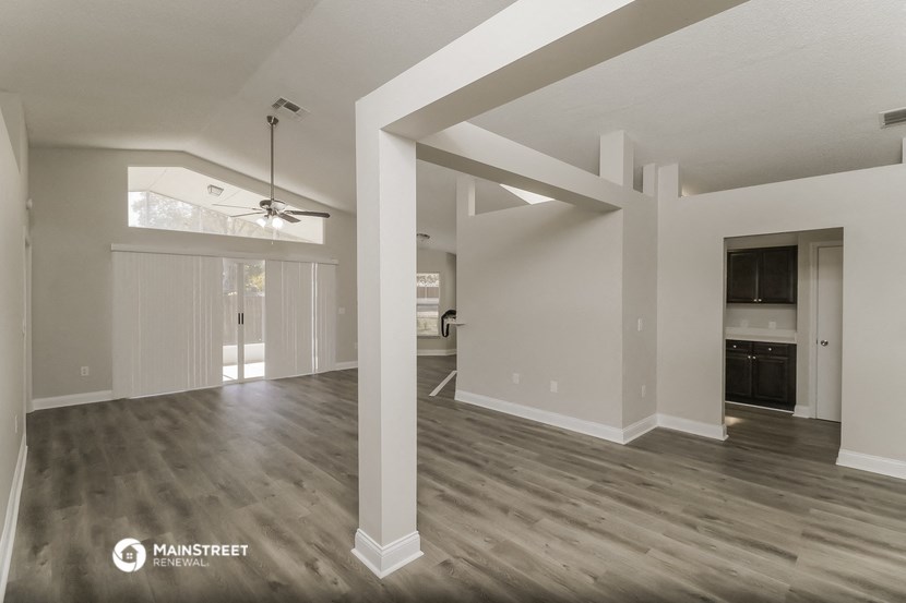 the living room and dining room of an open floor plan