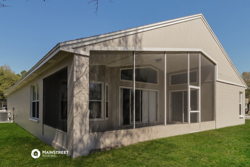 the exterior of a house with large glass windows
