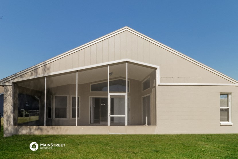 the front of a white building with glass doors