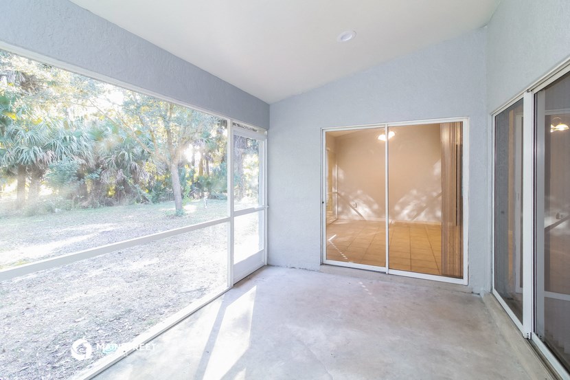 a living room with a sliding glass door and a patio