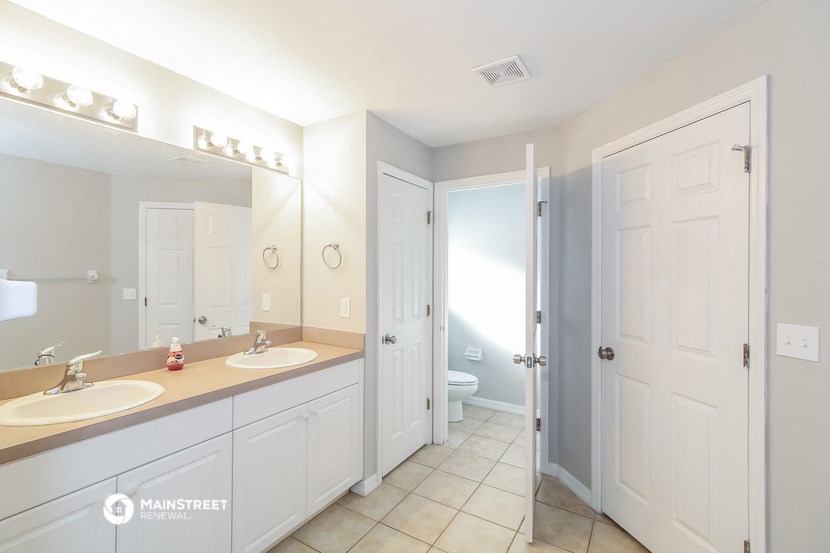 a bathroom with two sinks and a shower and a toilet