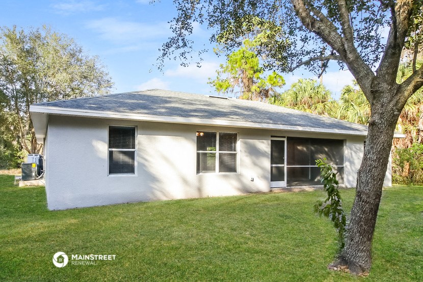a white house with a tree in front of it
