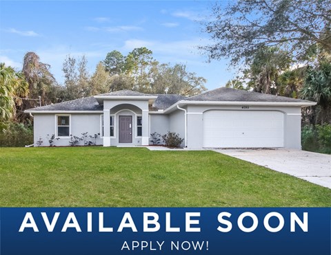 a white house with a lawn and a white garage door