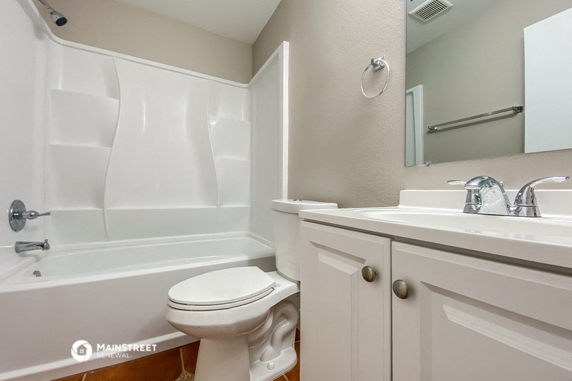 a bathroom with a sink toilet and a bath tub