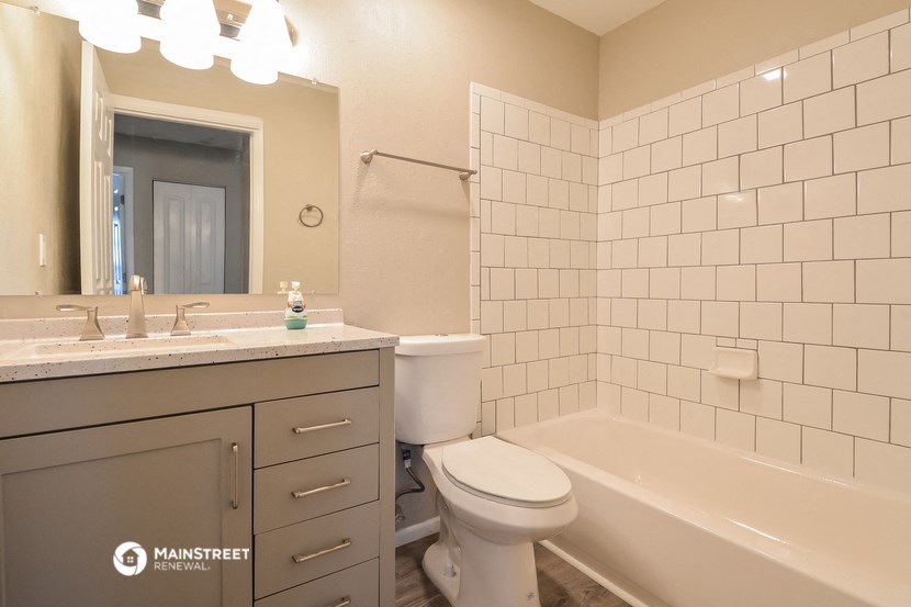 a bathroom with a sink toilet and bath tub