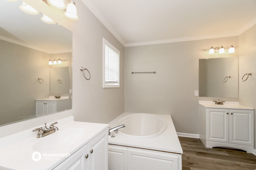a bathroom with a sink and a tub and a mirror