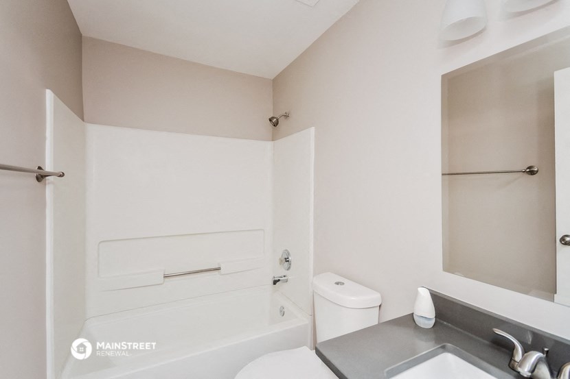 a bathroom with a sink and a toilet and a bath tub