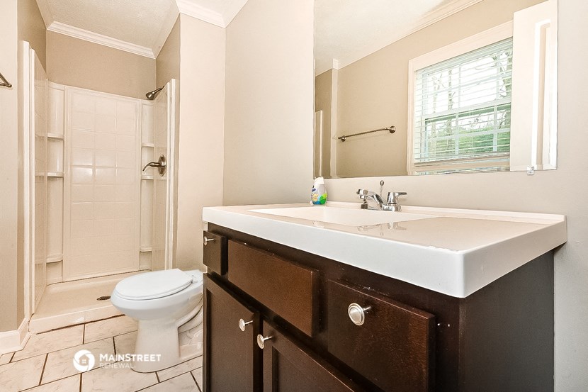 a bathroom with a sink and a toilet and a shower