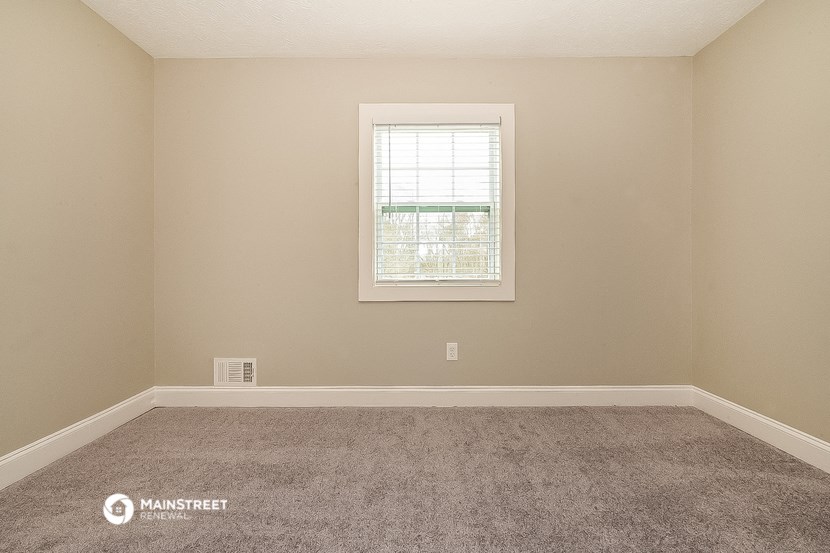 a room with carpet and a window
