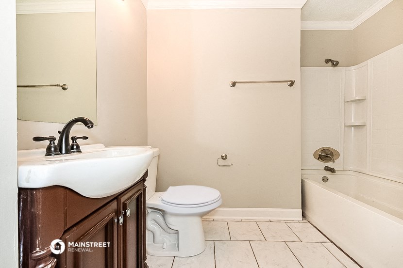 a bathroom with a sink and a toilet and a tub