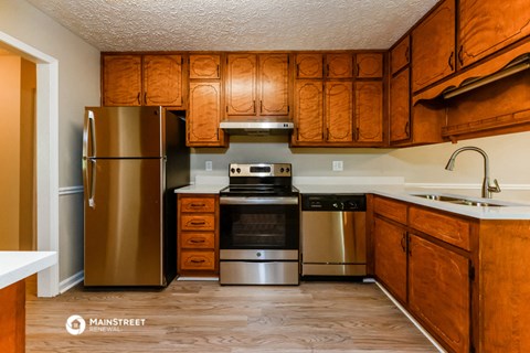 a kitchen with stainless steel appliances and wooden cabinets