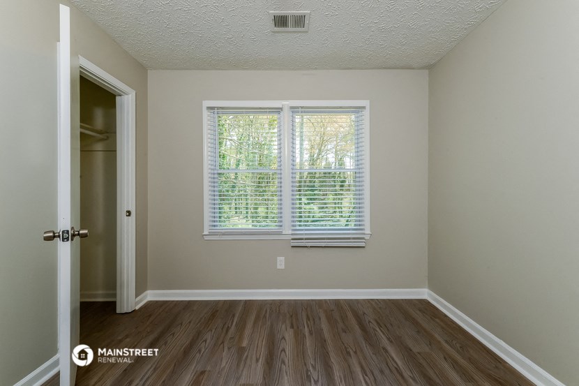 the living room of an empty house with a large window