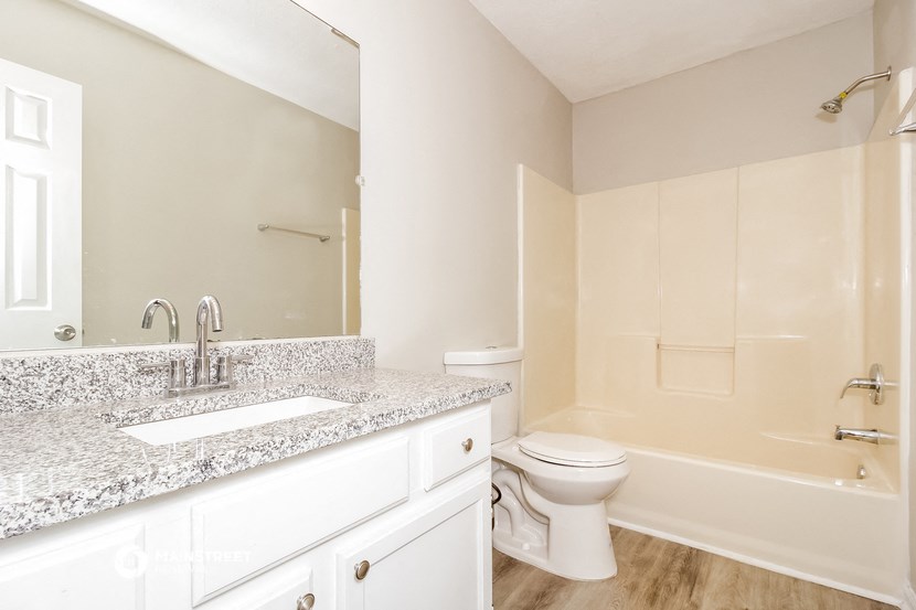 a bathroom with a sink and a toilet and a bath tub