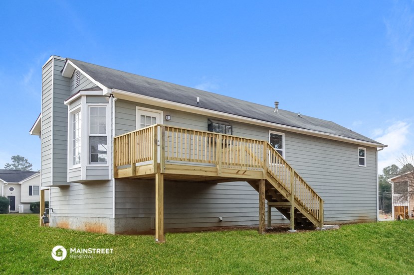 the back of a house with a deck and a porch