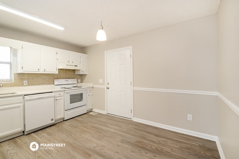 the kitchen of our studio apartment atrium with white appliances and white cabinets