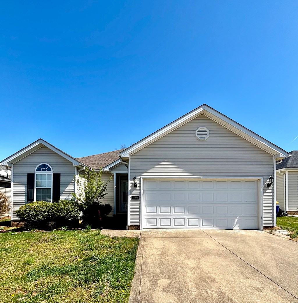 A house with a white garage door and a brown roof.