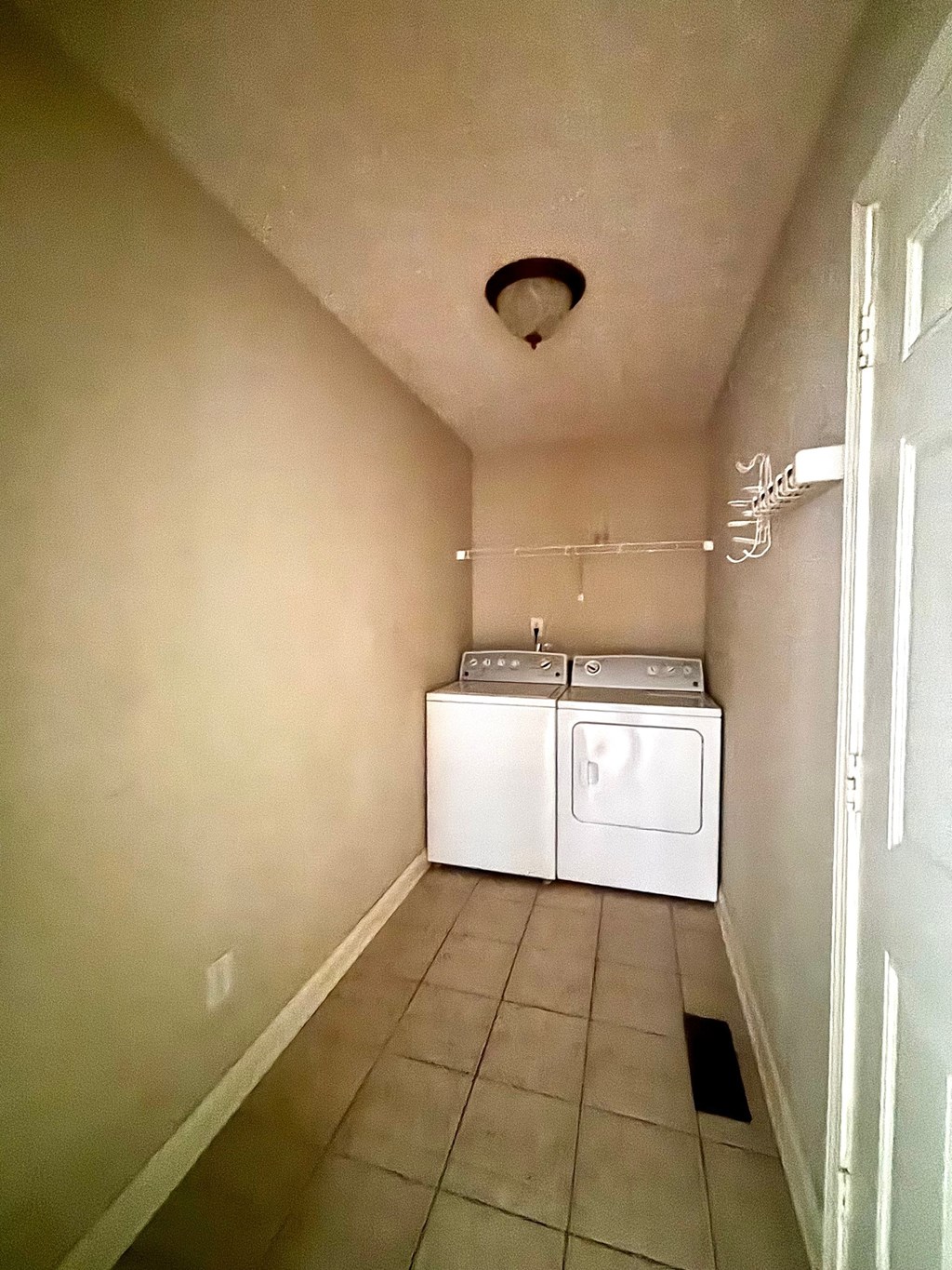 A laundry room with a washer and dryer.