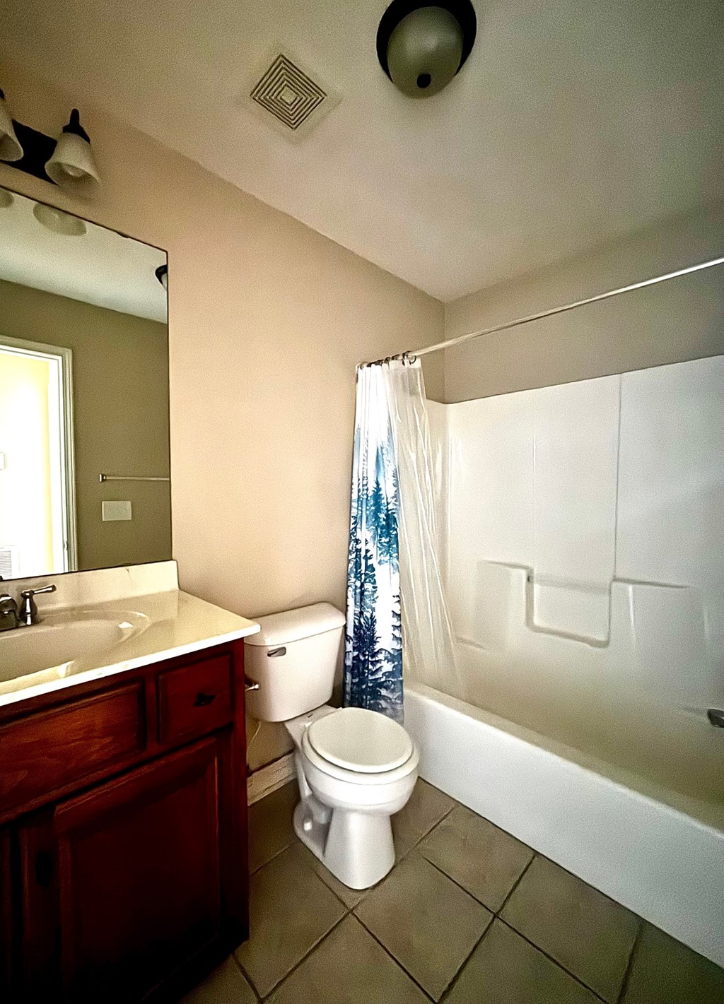 A bathroom with a toilet, sink, and bathtub.