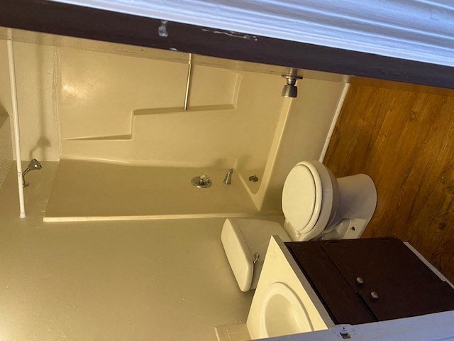 a bathroom with a toilet and a bath tub
