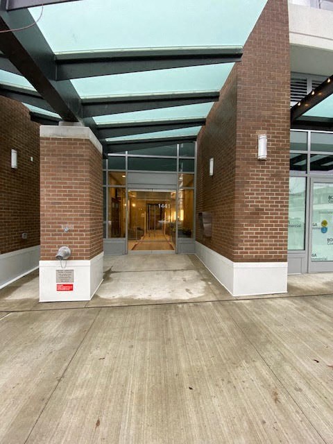 an empty lobby of a building with brick pillars