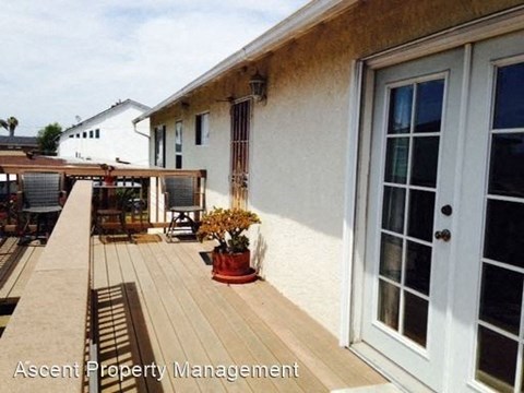 a house with a wooden deck and a door