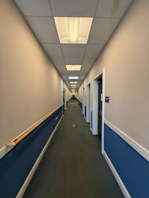 A long hallway with doors on both sides.
